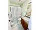 Bright bathroom features a patterned shower curtain and light green walls at 355 Pico Ct, Lakeland, FL 33809