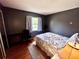 This bedroom features hardwood floors and a brightly lit window at 355 Pico Ct, Lakeland, FL 33809