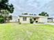 A single-story home with a detached garage and a spacious green lawn at 355 Pico Ct, Lakeland, FL 33809