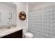 Bathroom with granite countertop and decorated shower curtain at 3685 Diving Dove Ln, Bartow, FL 33830