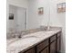 Bathroom featuring double sinks with granite countertops and wooden cabinets at 3685 Diving Dove Ln, Bartow, FL 33830
