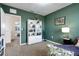Charming bedroom featuring green walls, a bookshelf, and a cozy seating area at 3685 Diving Dove Ln, Bartow, FL 33830