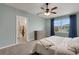 Relaxing bedroom features plush carpet, a ceiling fan, and access to the ensuite bathroom at 3685 Diving Dove Ln, Bartow, FL 33830