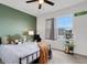 Bright bedroom featuring a ceiling fan, natural light from the large window, and stylish decorations at 3685 Diving Dove Ln, Bartow, FL 33830
