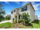 Exterior view of a spacious two-story home with a well-kept lawn and beautiful landscaping at 3685 Diving Dove Ln, Bartow, FL 33830