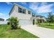 Side view of a beautiful two-story house, featuring a two-car garage and a well-maintained lawn at 3685 Diving Dove Ln, Bartow, FL 33830