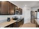 Modern kitchen featuring stainless steel appliances, granite countertops and dark wood cabinets at 3685 Diving Dove Ln, Bartow, FL 33830