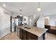 Open kitchen with stainless steel appliances, island with double sink and granite countertops at 3685 Diving Dove Ln, Bartow, FL 33830