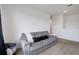 Well-lit living room featuring a comfortable gray couch and a minimalist interior at 3685 Diving Dove Ln, Bartow, FL 33830