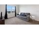 Comfortable living room featuring a gray couch and a large window with black curtains at 3685 Diving Dove Ln, Bartow, FL 33830