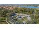 A scenic aerial view of the community featuring a central fountain, homes, and a lake in the background at 4124 Prima Lago Cir, Lakeland, FL 33810