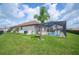 A sprawling backyard features a screened pool, verdant lawn, and privacy landscaping at 4124 Prima Lago Cir, Lakeland, FL 33810