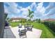 Landscaped backyard featuring Adirondack chairs and a well-maintained lawn at 4124 Prima Lago Cir, Lakeland, FL 33810