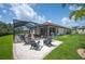 A backyard is fully landscaped with a pool, lounging chairs and plenty of seating areas at 4124 Prima Lago Cir, Lakeland, FL 33810