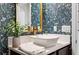 Charming bathroom with designer wallpaper, a modern vessel sink, and gold fixtures at 4124 Prima Lago Cir, Lakeland, FL 33810