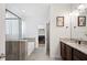 Elegant bathroom with granite countertops, a glass-enclosed shower, and a separate soaking tub at 4124 Prima Lago Cir, Lakeland, FL 33810