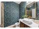 Stylish bathroom featuring vibrant floral wallpaper, a vessel sink, and a gold-framed mirror at 4124 Prima Lago Cir, Lakeland, FL 33810