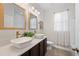 Bathroom with dual vessel sinks, framed mirrors, and sheer curtains over the window at 4124 Prima Lago Cir, Lakeland, FL 33810