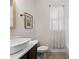 Bathroom featuring a vessel sink, tiled floor, and a window with white sheer curtains at 4124 Prima Lago Cir, Lakeland, FL 33810