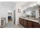 Bright bathroom featuring double vanity with granite countertop and walk-in closet at 4124 Prima Lago Cir, Lakeland, FL 33810