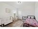bedroom with wood floors, a crib, a single bed, and a toy kitchen at 4124 Prima Lago Cir, Lakeland, FL 33810