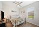 Cozy bedroom with hardwood floors, a window with blinds, and a ceiling fan at 4124 Prima Lago Cir, Lakeland, FL 33810