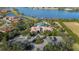 Aerial view showcasing the elegant clubhouse entrance, landscaped roundabout and lake in the background at 4124 Prima Lago Cir, Lakeland, FL 33810