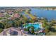 Stunning aerial view of the community pool, showcasing beautiful landscaping and lake views at 4124 Prima Lago Cir, Lakeland, FL 33810