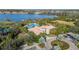 Overhead view of the community pool area, showcasing the clubhouse, lake and surrounding greenery at 4124 Prima Lago Cir, Lakeland, FL 33810