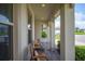 Inviting front porch featuring two chairs, providing a relaxing outdoor space with view of the neighborhood at 4124 Prima Lago Cir, Lakeland, FL 33810
