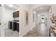 Hallway view showcasing tile flooring, modern decor, and arched doorways at 4124 Prima Lago Cir, Lakeland, FL 33810