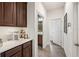 Hallway leading to a bathroom and butler's pantry with coffee station at 4124 Prima Lago Cir, Lakeland, FL 33810