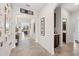 Hallway with tiled floor, arched doorways, and decorative wall hangings at 4124 Prima Lago Cir, Lakeland, FL 33810