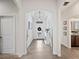 Hallway featuring a decorative wreath on a glass front door, leading to rooms beyond at 4124 Prima Lago Cir, Lakeland, FL 33810