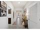 Hallway with tiled floor, arched doorways, and decorative console table at 4124 Prima Lago Cir, Lakeland, FL 33810