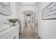 Long hallway showcasing neutral paint, arched doorways, and decorative accents at 4124 Prima Lago Cir, Lakeland, FL 33810