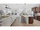 Bright, open-concept kitchen with island seating and views into the adjacent living and dining areas at 4124 Prima Lago Cir, Lakeland, FL 33810