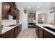 Stylish kitchen featuring dark cabinets, modern appliances, and sleek countertops with tiled floors at 4124 Prima Lago Cir, Lakeland, FL 33810