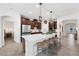 Bright and airy kitchen featuring a large island with seating, dark cabinetry, and modern stainless steel appliances at 4124 Prima Lago Cir, Lakeland, FL 33810