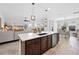 Open-concept kitchen with modern island, stainless steel appliances, and views into the adjacent living room at 4124 Prima Lago Cir, Lakeland, FL 33810