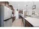 Spacious kitchen featuring stainless steel appliances, a large island, and dark cabinets with a built-in microwave at 4124 Prima Lago Cir, Lakeland, FL 33810