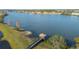 Picturesque lake view featuring a covered pier, fountain, and waterfront community at 4124 Prima Lago Cir, Lakeland, FL 33810