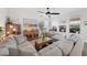 Comfortable living room with neutral decor, ceiling fan, and an abundance of natural light at 4124 Prima Lago Cir, Lakeland, FL 33810