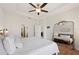 Bright main bedroom featuring a tray ceiling, generous natural light, and a large decorative mirror at 4124 Prima Lago Cir, Lakeland, FL 33810