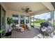 Relaxing screened patio with overhead fan, comfortable seating, and a view of the well-maintained backyard at 4124 Prima Lago Cir, Lakeland, FL 33810