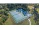 Aerial view of well-maintained community tennis and basketball courts surrounded by lush greenery at 4124 Prima Lago Cir, Lakeland, FL 33810