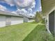 A view of the grassy backyard space, featuring views of the sides of neighboring homes at 4926 Pleasant Hollow Trl, Lakeland, FL 33811