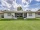 The backyard view shows the home's screened-in porch and the green lawn at 4926 Pleasant Hollow Trl, Lakeland, FL 33811