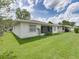 Backyard view with lush green grass and white siding at 4926 Pleasant Hollow Trl, Lakeland, FL 33811