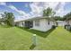 Backyard features white siding, screened-in porch, and lush landscaping at 4926 Pleasant Hollow Trl, Lakeland, FL 33811